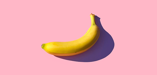 A Banana on a Pink Background — Wholesale Food in Coffs Harbour, NSW